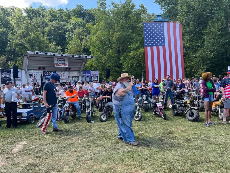Biggin Noble emceeing the festival with the crowd and mini rigs gathered behind him