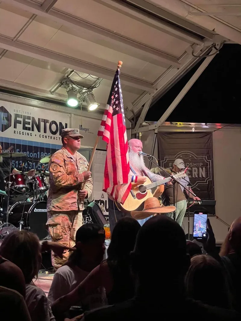 A color guard carries the American flag onstage during a performance