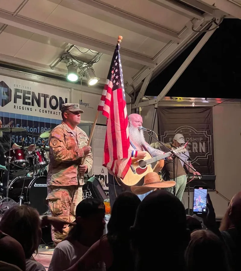 A color guard carries the American flag onstage during a performance