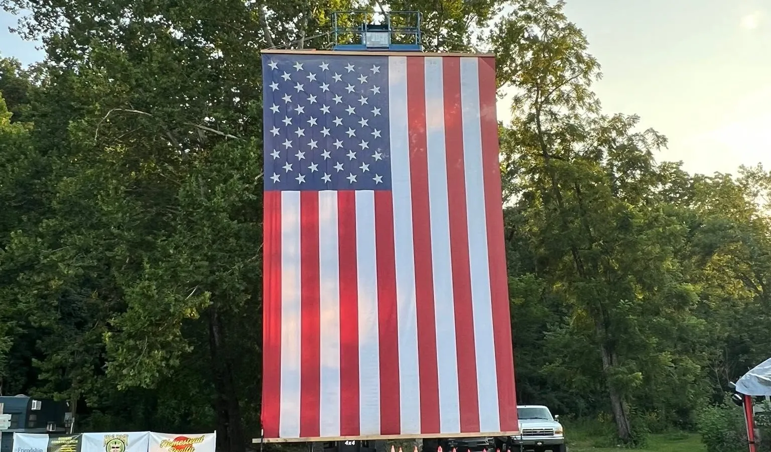 The giant American flag at Biggin Bash lit by the evening sun