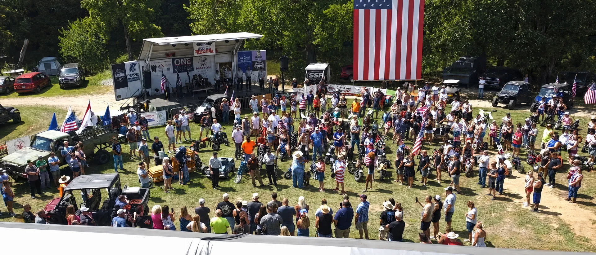 Aerial view of the Biggin Bash crowd gathered beneath a giant American flag